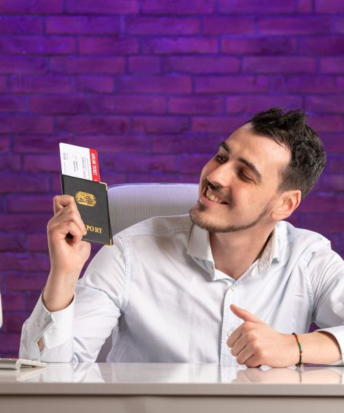 front-view-office-worker-sitting-his-working-place-holding-tickets-passport